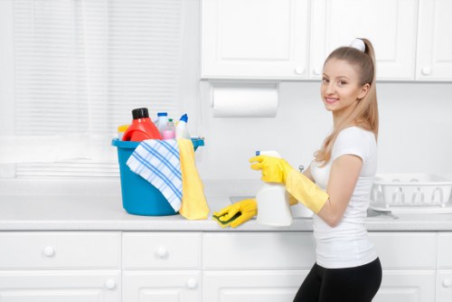 Cleaning technician preparing carpet cleaning equipment with safety measures in place